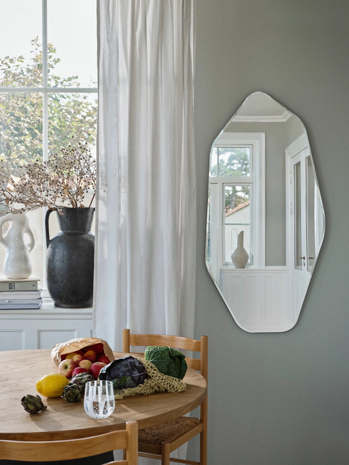 A DESIGNER MIRROR IN A SCULPTURAL FORMAT